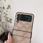Looopix Coach Z Flip Samsung Phone Case with Finger Strap