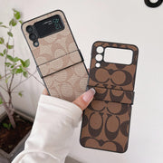 Looopix Coach Z Flip Samsung Phone Case with Finger Strap